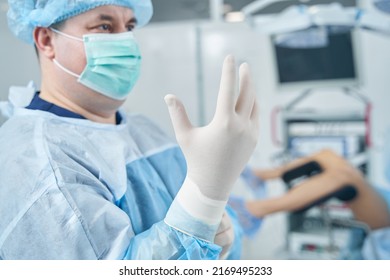 Serious Male Gynecologist Preparing For The Examination