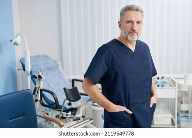 Serious Male Gynecologist Standing In His Office