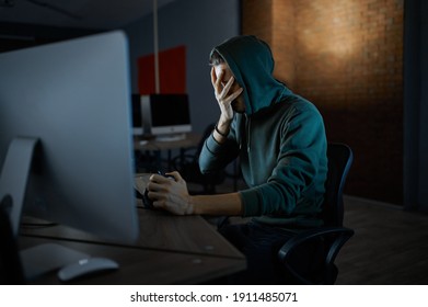 Serious Male Hacker In Hood Works On Computer