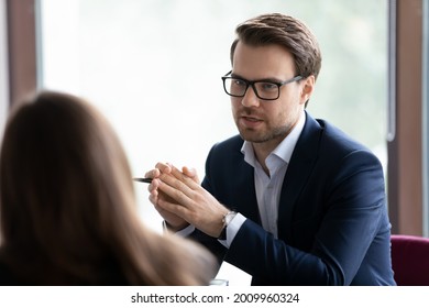 Serious male manager, lawyer, broker, talking to client, giving consultation, advice. Businessman, employer interviewing job candidate for hiring. Business leader in glasses meeting with employee - Shutterstock ID 2009960324