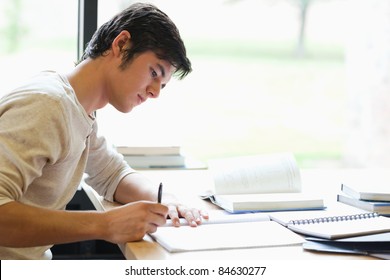 Komoly férfi diák írás egy laboratóriumban Stockfotó