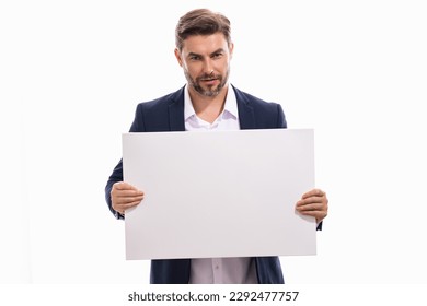 Serious man with blank banner ad, posing isolated over studio background. Portrait of attractive man holding empty blank poster. Man showing blank poster. Male presenting signboard, billboard banner.