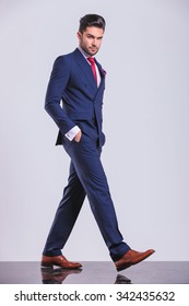 Serious Man In Business Suit Pose While Walking With Hands In Pockets