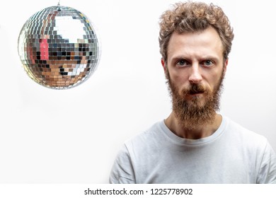 Serious Man With Disco Mirror Ball Aside Looking At Camera With Confident Look