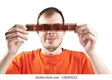 serious man with film strip before the eyes isolated on white symbol photographer, film fandirector film editing analog film, glasses 3 d effect, the idea of ??theater, illusion, visual distortion - Powered by Shutterstock