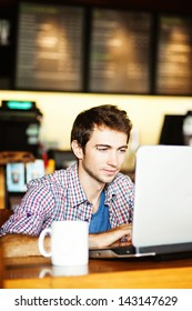 Serious Man With Laptop In Cafe