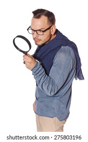 Serious man looking through magnifying glass, over white background. Search concept.