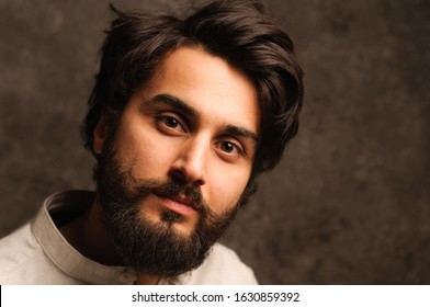 Serious Man Portrait With Dark Hair On A Dreamy Background