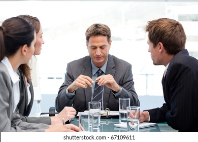 Serious Manager At A Table With His Team During A Meeting At The Office