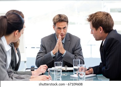 Serious Manager Talking To His Team During A Meeting In The Office