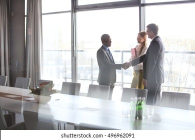 Serious mature businessman talking on mobile phone in office- Corporate Business Portraits of real life business teams - Shutterstock ID 496962091