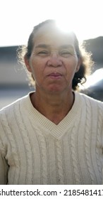 Serious Mature Woman In 70s Standing Outside Looking At Camera. A Hispanic Latin Senior Person