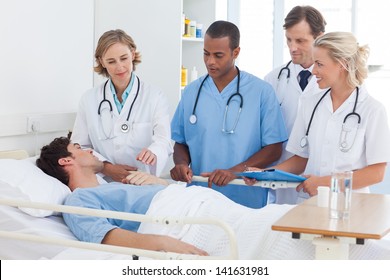 Serious Medical Team Around The Bed Of A Patient