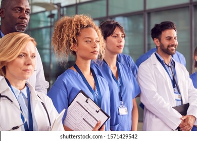 Serious Medical Team Standing In Modern Hospital Building