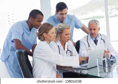 Serious Medical Team Using A Laptop In A Bright Office