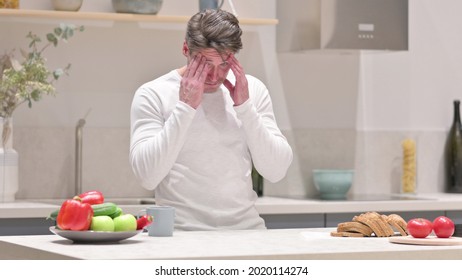 Serious Middle Aged Man Feeling Worried While Standing In Kitchen