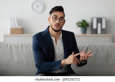 Serious Middle Eastern Male Psychologist Gesturing And Talking To Camera During Therapy Session At Clinic. Psychotherapy Services, Mental Health Professional Concept