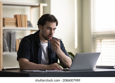 Serious Millennial Business Man Recording Audio Message On Smartphone, Giving Vocal Command At Mobile Phone Speaker To Virtual Assistant For Online Search, Using Voice Recognition App