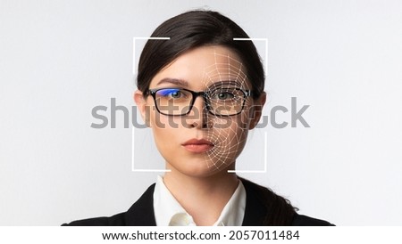 Serious millennial caucasian business woman in glasses and smart technology for face recognition, double exposure. Biometric identification, futuristic cyber security, scanning and facial detection