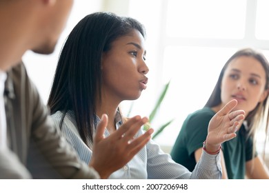 Serious mixed race Black student girl, intern speaking at learning seminar, conference lecture, asking question to teacher or coworkers. Employee, manager speaking at meeting, presenting solution