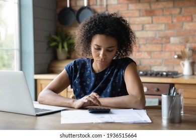 Serious Mixed Race Female Calculate Utility Charges Check Payments Sum By Loan Contract To Avoid Scam. Thoughtful Young Black Woman Engaged In Planning Monthly Budget Count Tax Rate Before Pay Online