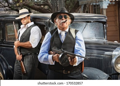 Serious Mob Boss With Gun And Guard Near Car