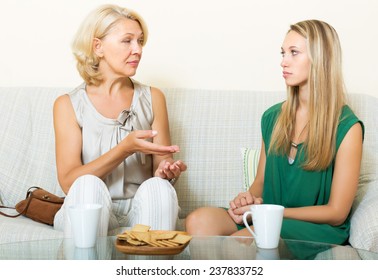 Serious Mother And Daughter Talking In Home