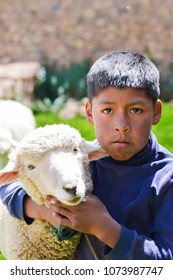 Serious Native American Child With A Sheep.