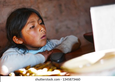 Serious Native American Kid Using Notebook.