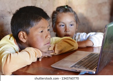 Serious native american kids using notebook.