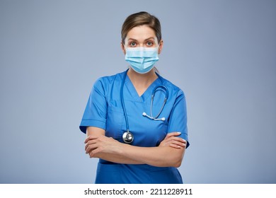 Serious Nurse Woman Or Doctor In Blue Medical Mask And Suit. Isolated Female Portrait.