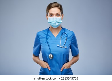 Serious Nurse Woman Or Doctor In Blue Medical Mask And Suit. Isolated Female Portrait.