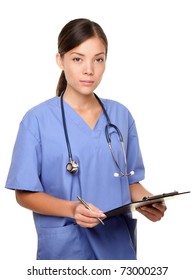 Serious Nurse / Young Female Medical Doctor Isolated On White Background. Multiracial Asian Caucausian Woman Health Care Professional Looking At Camera Standing With Clipboard