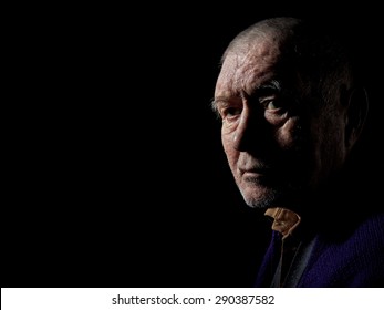 Serious Old Man Senior On Black Background Looking At Camera