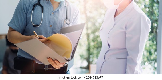 Serious Old Mature Professional Male Doctor Using Laptop Computer In Hospital Office Watching Medical Webinar Training, Writing In Healthcare Report, Consulting Patient Online At Telemedicine Meeting.