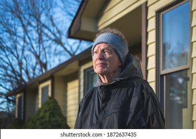 Serious Older Man Standing In Front Of His House Looking Up; Late Fall In Missouri, Midwest