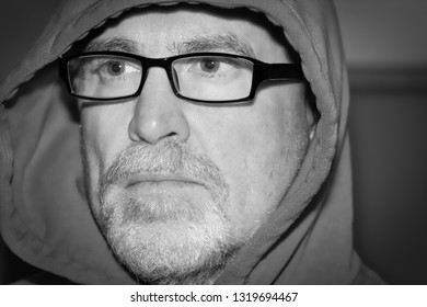 Serious Older Man Wearing Glasses Staring Ahead In Black And White Portrait