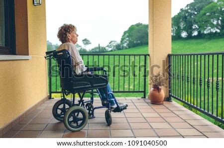 Similar – Older woman in a wheelchair