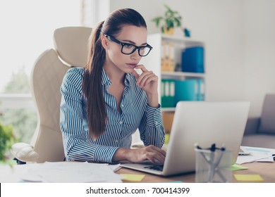 Serious Pensive Young Business Lady Economist Is Thinking Which Decision To Make At Her Modern Light Work Place In Office, Wearing Strict Outfit And Glasses