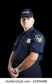 Serious Portrait Of A Policeman On A Black Background.