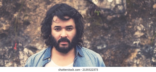 Serious powerful man with full beard outdoor in urban style