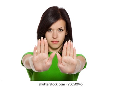 Serious Pretty Woman Making Stop Hand Sign Palm Gesture, Young Girl Wear Green Shirt, Isolated Over White Background