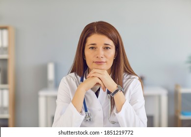 Serious Professional Doctor, Competent Understanding Physician, Looking At Camera And Listening To You. Head Shot Of Confident Young Woman For Online Consultation, Video Call Or Staff Profile Picture