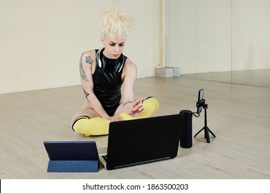 Serious Professional Female Dancer Setting Computer, Smartphone And Tablet To Host Online Dance Lesson For Her Clients