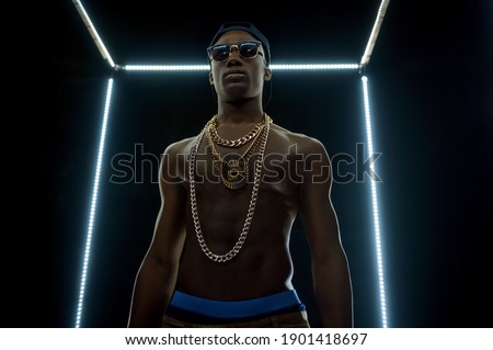 Serious rapper in gold chains, bottom view