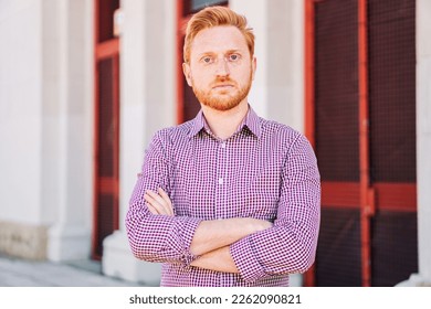 Serious Redhead Man Looking at Camera standing outdoors. Close Up Portrait of sad young guy. high quality photo - Shutterstock ID 2262090821