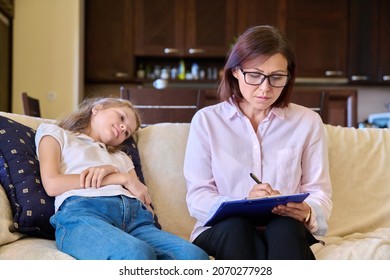 Serious Sad Child Girl And Female Psychologist Teacher At Session