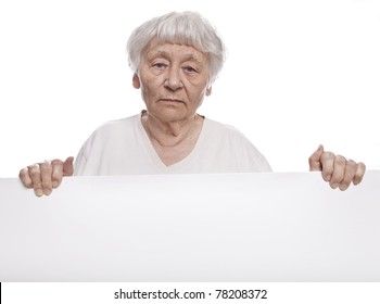 Serious Senior Woman Holding A Blank Sign