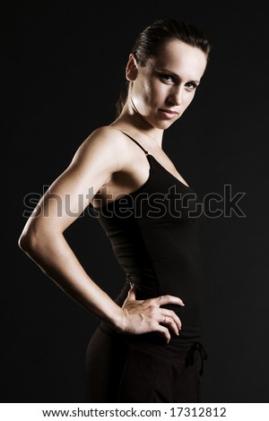 Similar – Close up front upper body portrait of one young athletic woman in sportswear in gym over dark background, looking at camera