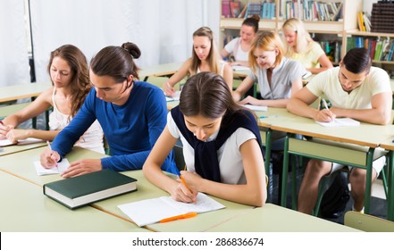 Serious student listening attentively during lecture in the classroom - Shutterstock ID 286836674